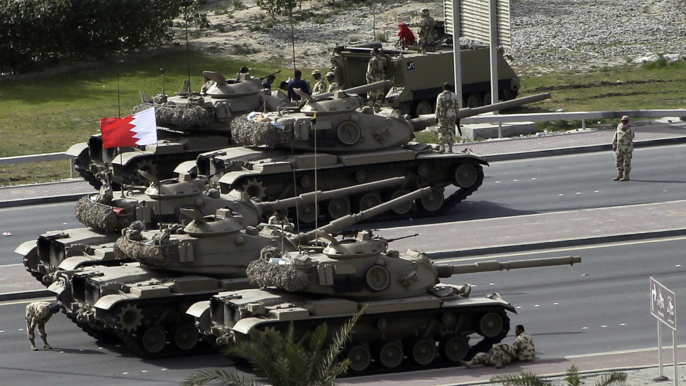 Bahraini army tanks take position near Pearl Square in Manama on Thursday after anti-riot police stormed through the square.