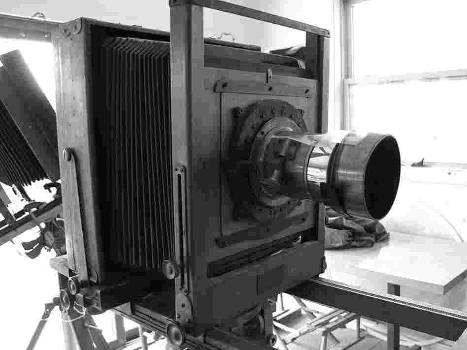 Sally Mann shoots with antique view cameras from the early 1900s, the kind where you duck under a cloth to take the picture. They have hulking wooden frames, accordion-like bellows and long brass lenses held together with tape, with mold growing inside. 