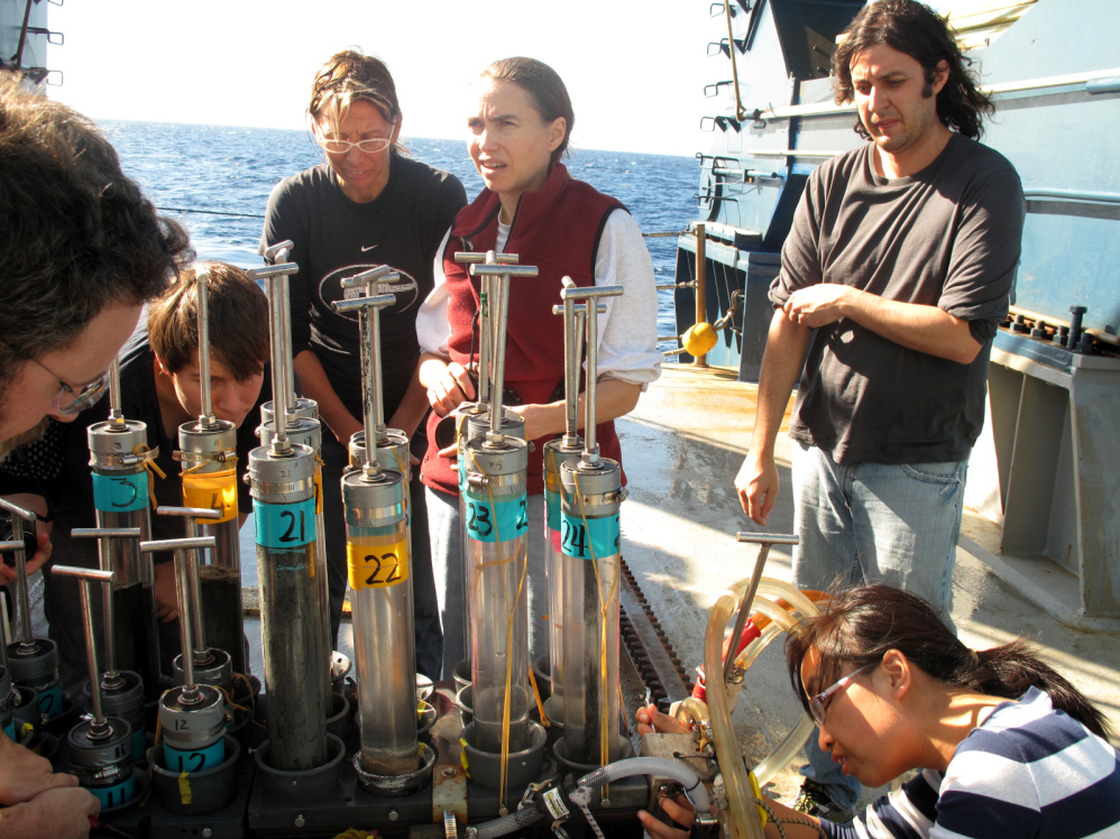 Researchers aboard the Atlantis, a research vessel operated by the Woods Hole Oceanographic Institution, examine core samples brought up from the sea floor of the Gulf of Mexico by the deep-sea submersible Alvin on Nov. 24, 2010. The scientific community is conflicted about the lack of direction, coordination and funding in studying the aftermath of the Gulf of Mexico oil spill.
