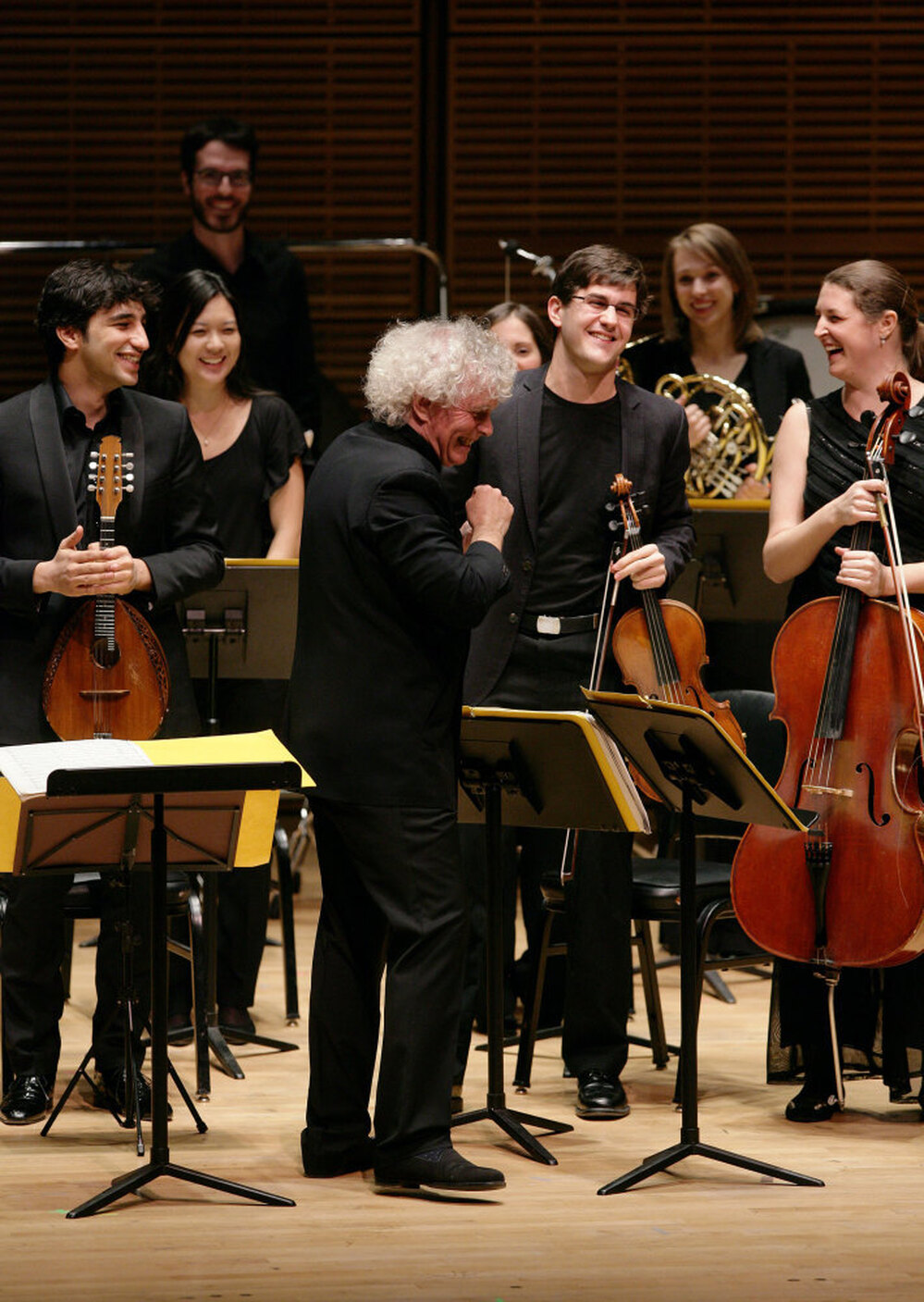 The Ensemble ACJW, conducted by Sir Simon Rattle (center), features musicians from the Academy, sponsored by Carnegie Hall and the Juilliard School. The violist to the right of Rattle is Nathan Schram.