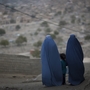 A girl stands among Afghan women clad in burqas  in Kabul last October.