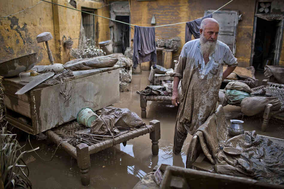 A Pakistani man surveys damage to his flood affected home on August 2, 2010 in Nowshera, Pakistan.