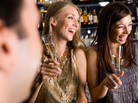 Two women laughing with drinks. Two women laughing with drinks.