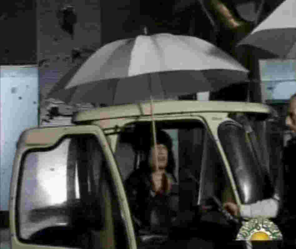 In this video image broadcast on Libyan state television early Tuesday, leader Moammar Gadhafi is shown. Gadhafi appeared for less than a minute on state television and made brief remarks to say he was in the capital Tripoli and deny rumors he had to fled to Venezuela amid the unrest sweeping his country. In this video image broadcast on Libyan state television early Tuesday, leader Moammar Gadhafi is shown. Gadhafi appeared for less than a minute on state television and made brief remarks to say he was in the capital Tripoli and deny rumors he had to fled to Venezuela amid the unrest sweeping his country.