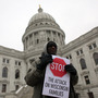 A protester rallied outside the Wisconsin State Capitol in Madison on Monday. A protester rallied outside the Wisconsin State Capitol in Madison on Monday.