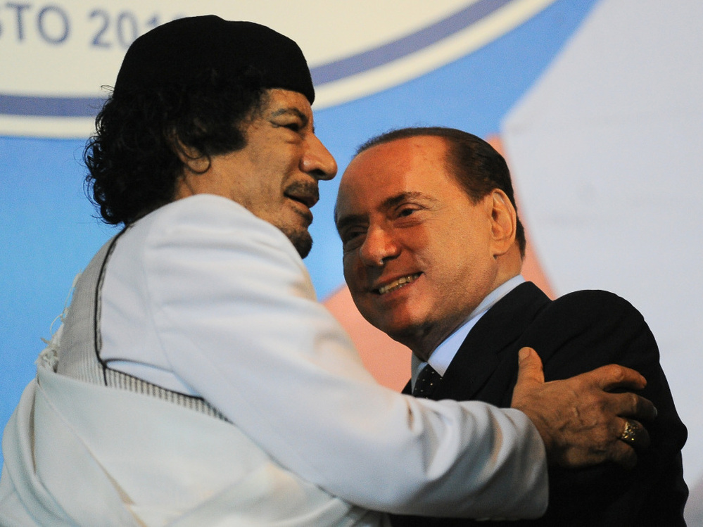 Libyan leader Moammar Gadhafi (left) embraces Italian Prime Mnister Silvio Berlusconi at the end of an equestrian show in Rome on Aug. 30.