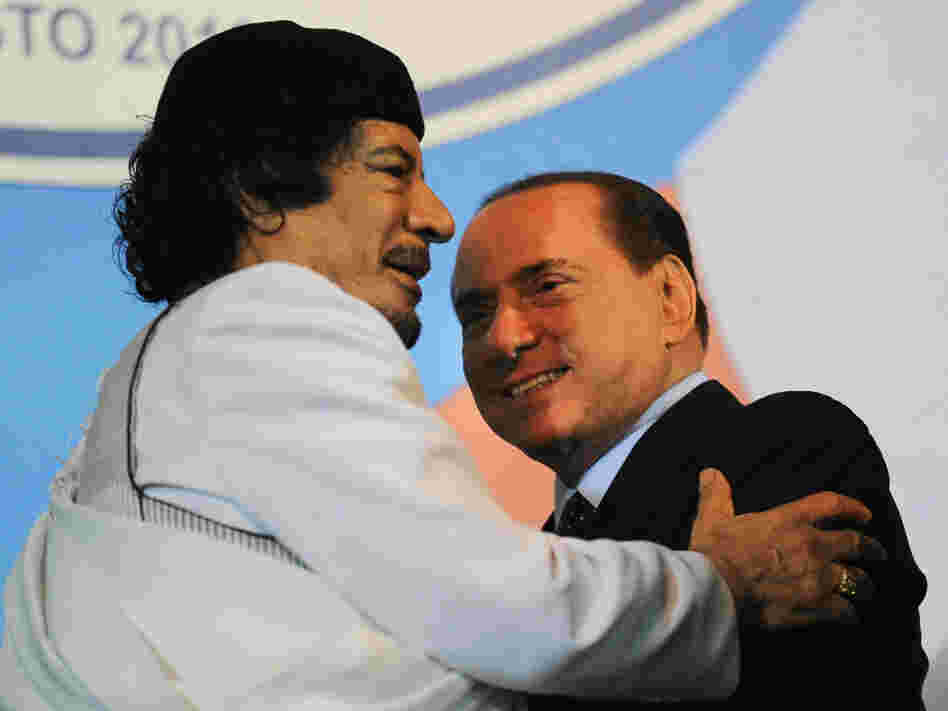 Libyan leader Moammar Gadhafi (left) embraces Italian Prime Mnister Silvio Berlusconi at the end of an equestrian show in Rome on Aug. 30.
