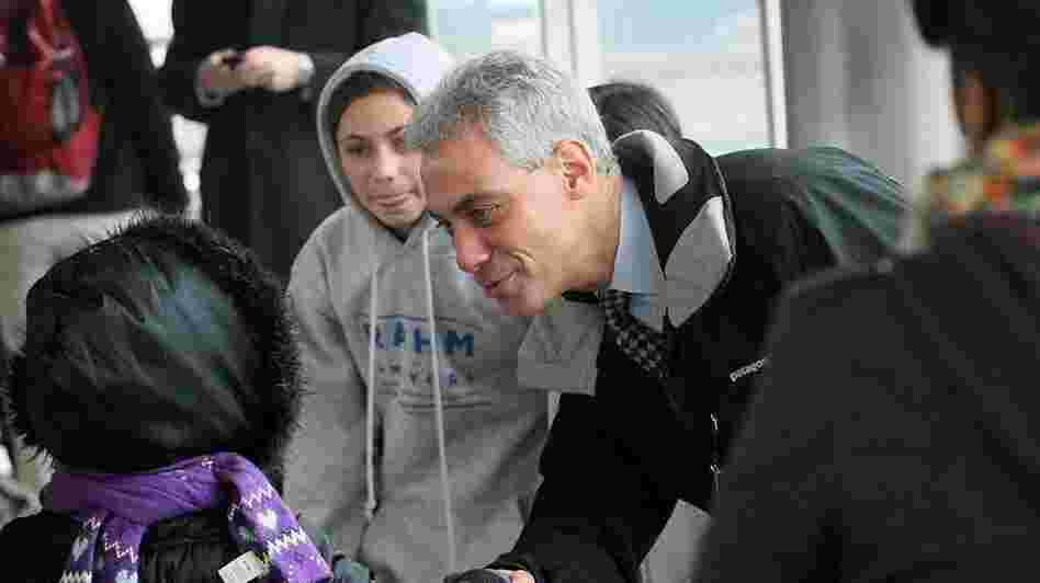 Rahm Emanuel, campaigning for mayor, greets Chicago commuters early this morning.  Polls close at 7 pm Central.