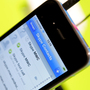 A mobile phone shows a Skype application. A mobile phone shows a Skype application.