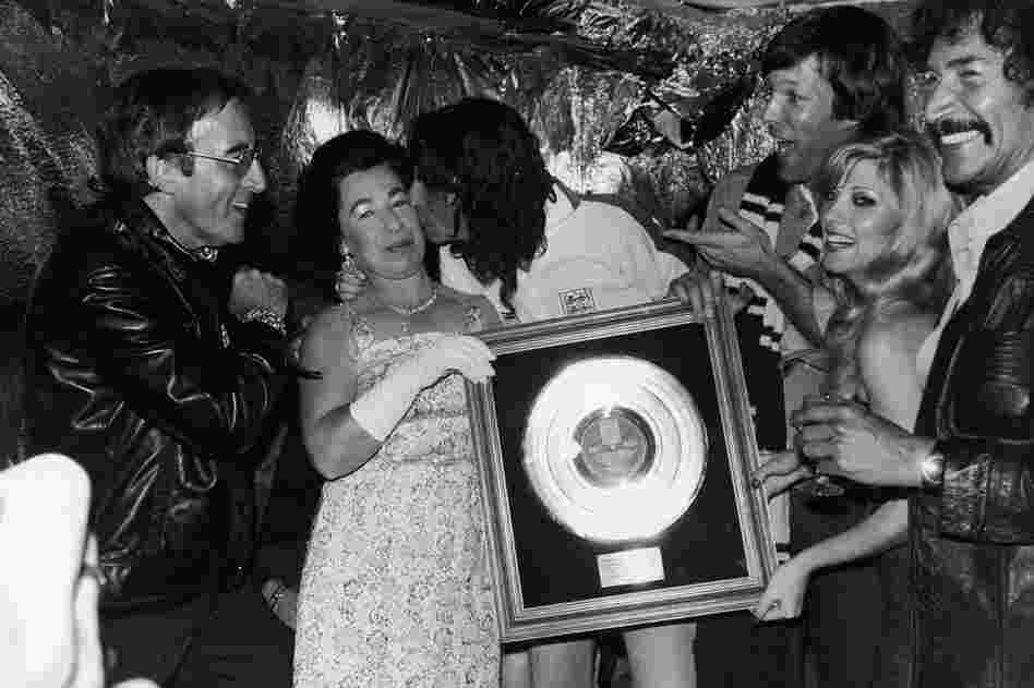 Although struggling with alcohol addiction through the rest of the '70s and early 1980s, Cooper continued to release hit albums and groundbreaking music videos. But after being rehospitalized in 1983 for alcoholism, he sobered up and released four more albums by the end of the '80s. Here, Cooper kisses a Queen Elizabeth II impersonator while holding his gold record plaque, in 1975. (Express New...