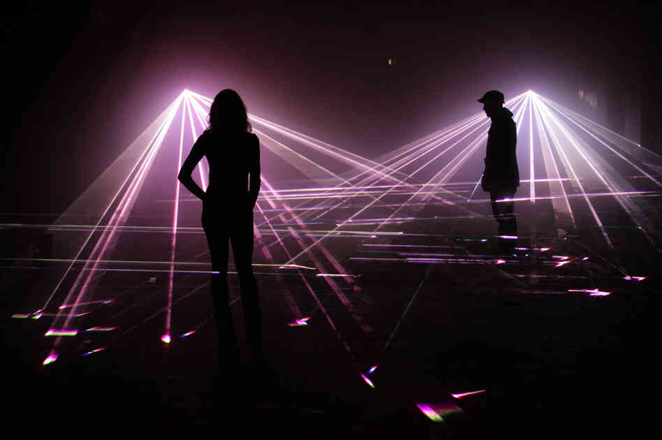 Artists pose in a laser projection entitled 'Speed of Light' at the Bargehouse on March 30, 2010 in London, England. Artists pose in a laser projection entitled 'Speed of Light' at the Bargehouse on March 30, 2010 in London, England.