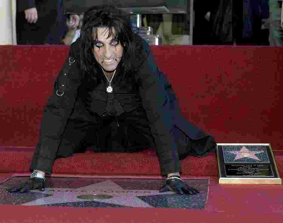 Cooper touches his star, which was installed on the Hollywood Walk of Fame in 2003 in Los Angeles. 
