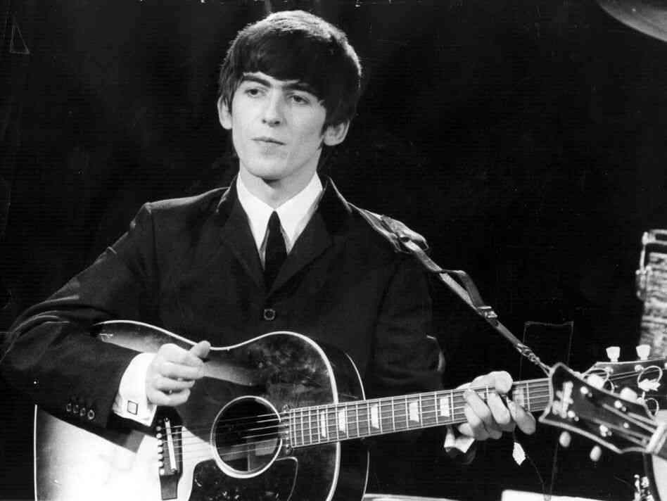George Harrison performs with The Beatles in 1963.