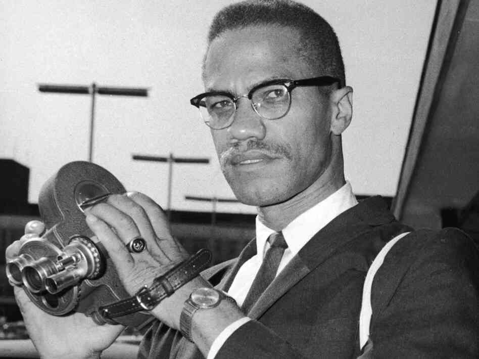 Malcolm X with film camera in Africa. Malcolm x, Black history, Rare