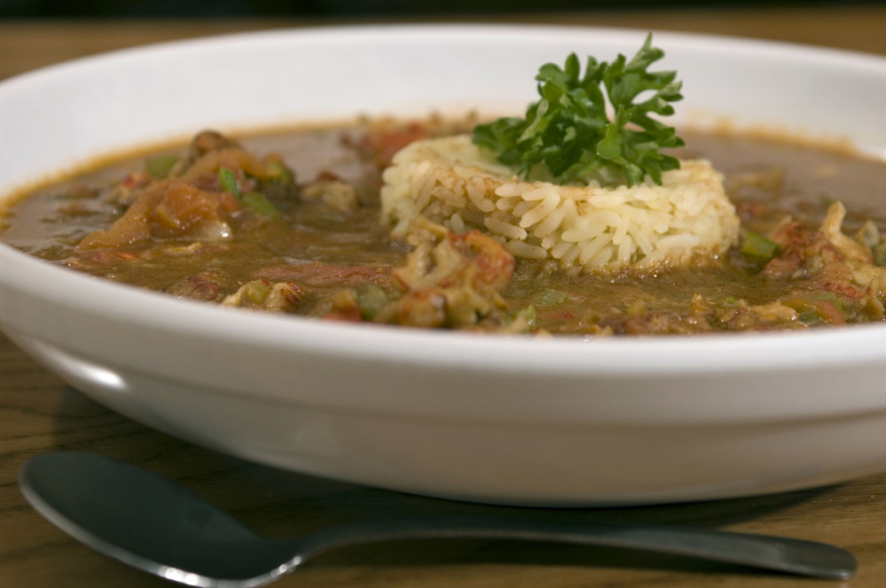 A bowl of gumbo with rice.