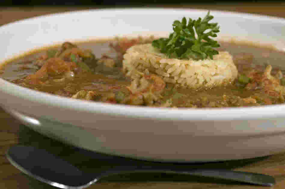 A bowl of gumbo with rice.