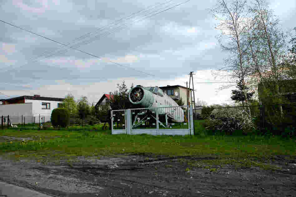 The carcass of a communist-era plane decays in the front lawn of home near Oswiecim.