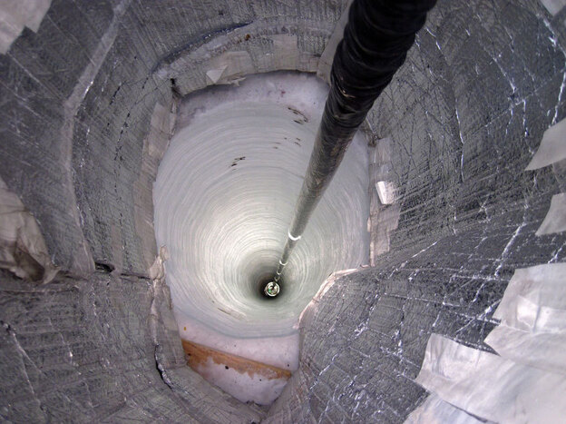 A light detector is lowered into the IceCube Neutrino Observatory near the South Pole, which acts as a neutrino detector in search of the elusive subatomic particle.
