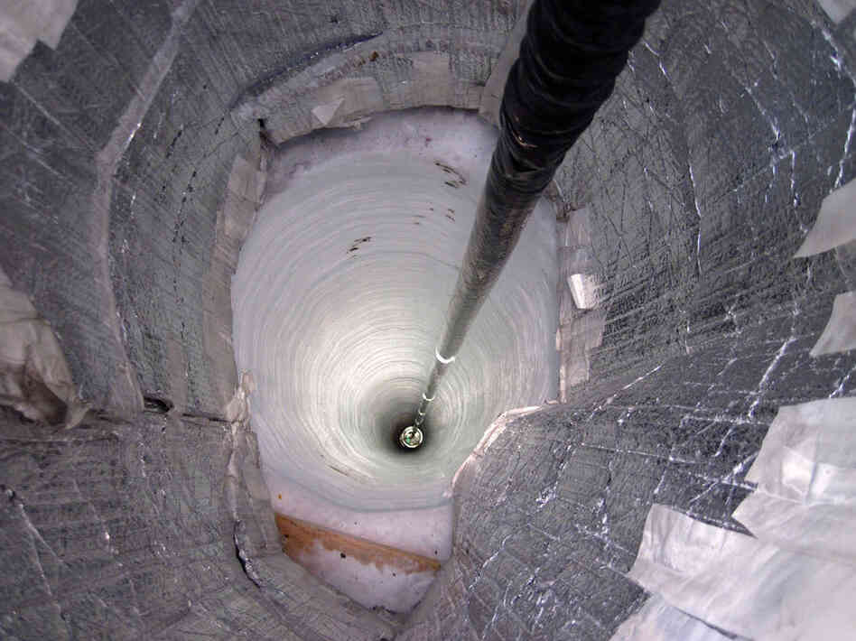 A light detector is lowered into the IceCube Neutrino Observatory near the South Pole, which acts as a neutrino detector in search of the elusive subatomic particle.
