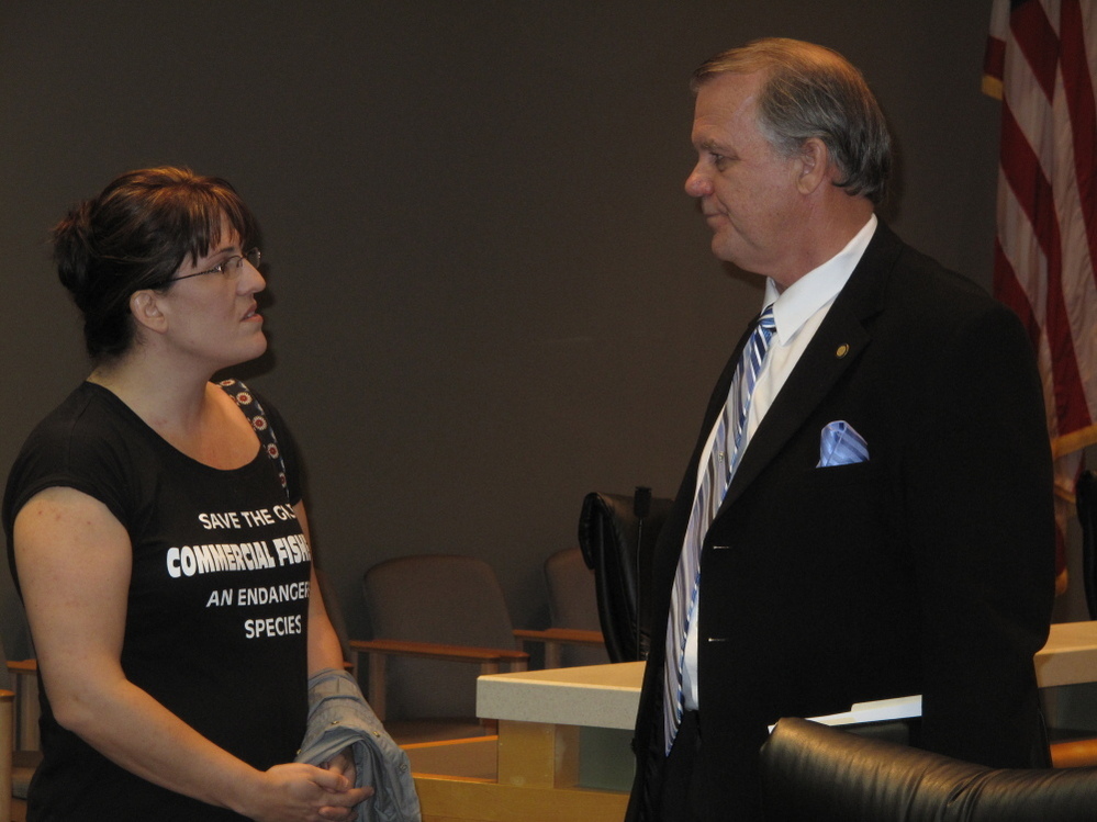 Florida state Rep. Doug Broxson (R-Gulf Breeze) listens as Kathryn Birren, owner of Hernando Beach Seafood, expresses her frustration with the claims process in the aftermath of the BP oil spill. She says business is down about 70 percent in her family's commercial fishing operation.