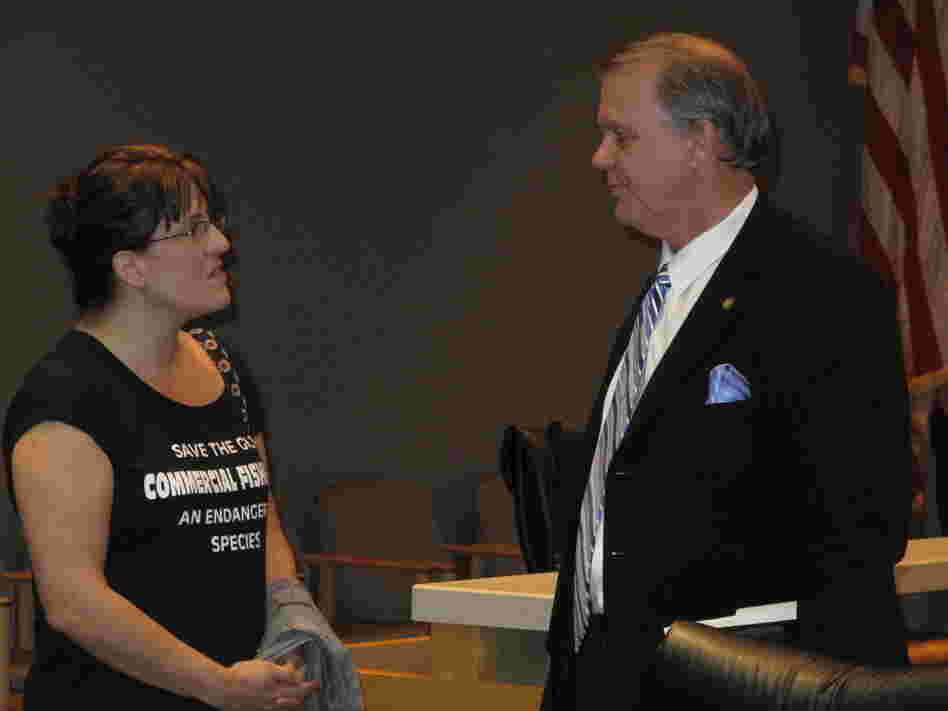 Florida state Rep. Doug Broxson (R-Gulf Breeze) listens as Kathryn Birren, owner of Hernando Beach Seafood, expresses her frustration with the claims process in the aftermath of the BP oil spill. She says business is down about 70 percent in her family's commercial fishing operation.