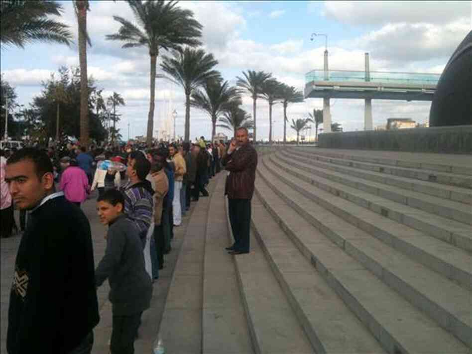 Demonstrators protect the Library of Alexandria by joining hands as marchers pass by. "What happened was pure magic," says the head of the library.