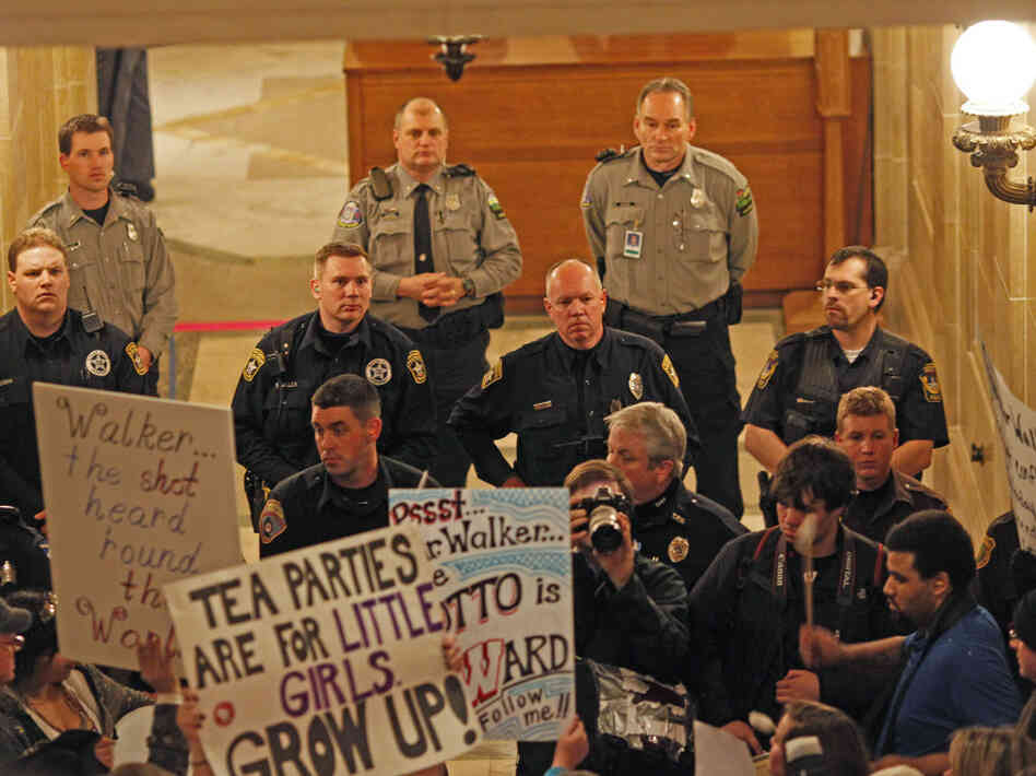 Police and protesters outside Wisconsin Gov. Scott Walker's office, Feb. 22, 2011.