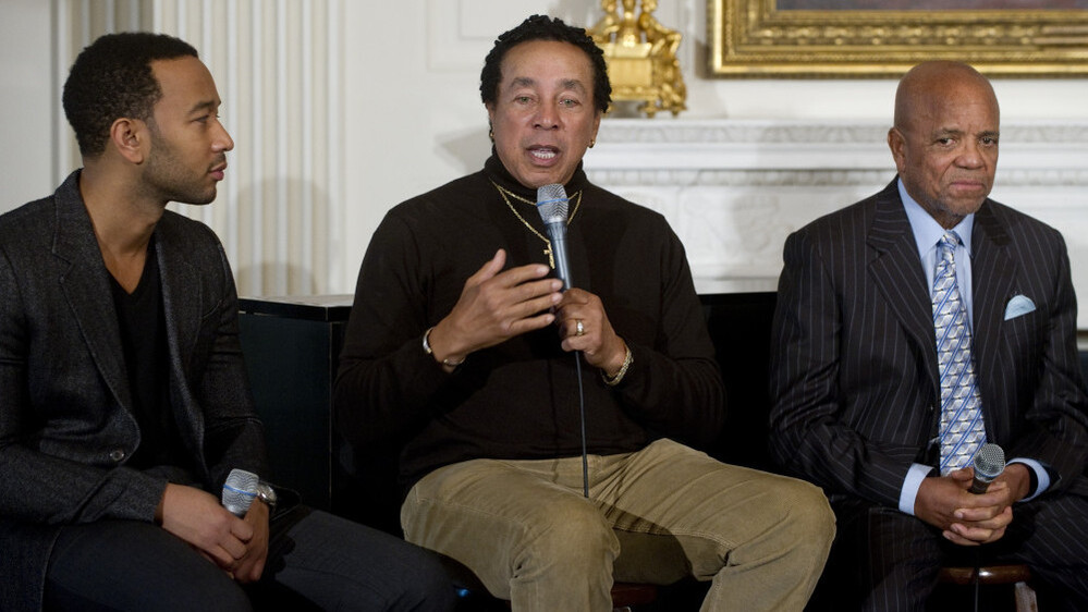 Smokey Robinson addresses the crowd at Thursday's White House musical event, flanked by singer John Legend (left) and Motown founder Berry Gordy.