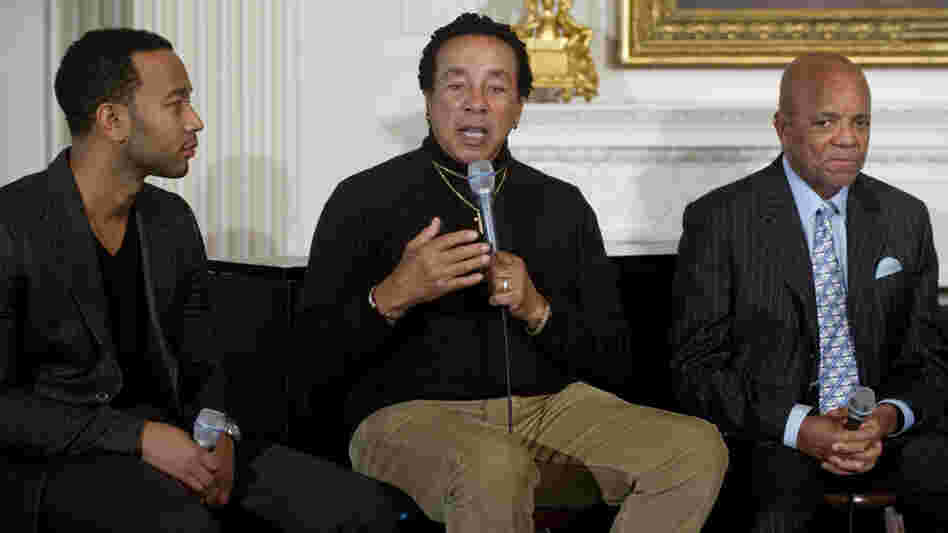 Smokey Robinson addresses the crowd at Thursday's White House musical event, flanked by singer John Legend (left) and Motown founder Berry Gordy.