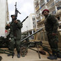 Gunmen prepared to fight against Libyan leader Moammar Gadhafi stand on a small military truck with weapons taken from a Libyan military base in Benghazi on Thursday.