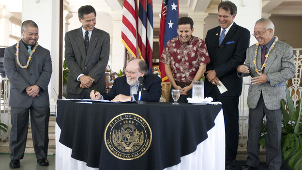 Hawaii lawmakers look on as   Hawaii Gov. Neil Abercrombie signs the Hawaii Civil Unions bill into law.