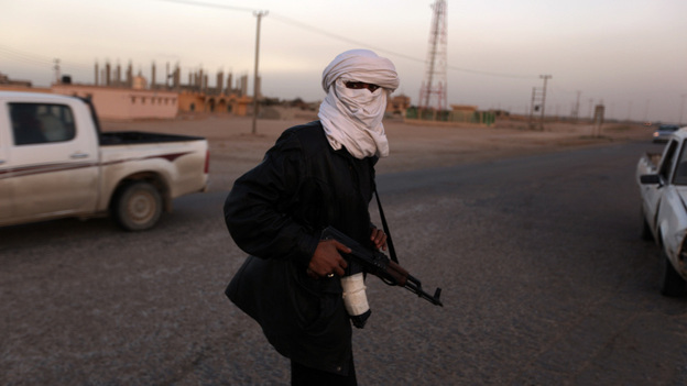 A Libyan policeman who defected to the side of anti-government protesters manned a checkpoint in the opposition-held, eastern city of Tobruk on Thursday.