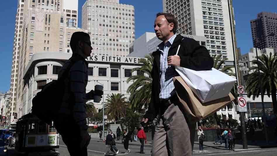 A pedestrian carries shopping bags as he walks through Union Square in San Francisco. The Conference Board's Consumer Confidence Index reached the highest level in three years in February. A pedestrian carries shopping bags as he walks through Union Square in San Francisco. The Conference Board's Consumer Confidence Index reached the highest level in three years in February.
