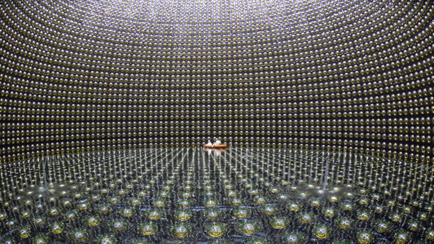 Workers float on a raft in the Super-Kamiokande neutrino observatory which lies beneath Mount Kamioka in Hida, Japan.