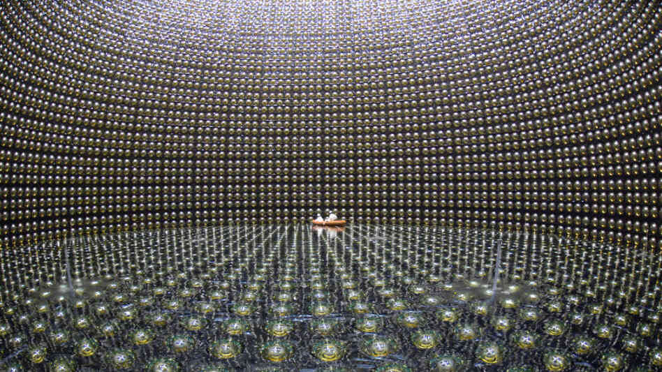 Workers float on a raft in the Super-Kamiokande neutrino observatory which lies beneath Mount Kamioka in Hida, Japan.