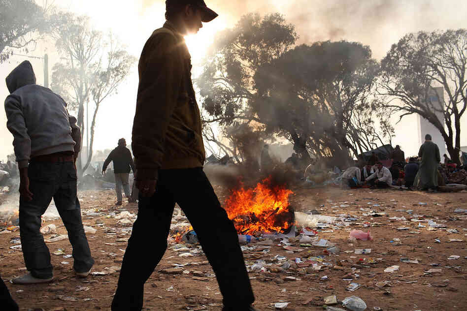 Trash fires burn at a border area in Tunisia on Thursday, where migrant workers from Libya are living in squalid conditions. Tunisia's situation is quickly turning into a humanitarian emergency as the country is overwhelmed with refugees. 
