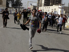 Protesters run as they chant anti-Iraqi government slogans during a protest in Baghdad's Tahrir Square. Hundreds of demonstrators converged on central Baghdad as part of a rally inspired by uprisings across the Middle East and dubbed the "Day of Rage." Protesters run as they chant anti-Iraqi government slogans during a protest in Baghdad's Tahrir Square. Hundreds of demonstrators converged on central Baghdad as part of a rally inspired by uprisings across the Middle East and dubbed the "Day of Rage."