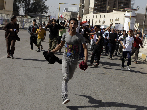 Protesters run as they chant anti-Iraqi government slogans during a protest in Baghdad's Tahrir Square. Hundreds of demonstrators converged on central Baghdad as part of a rally inspired by uprisings across the Middle East and dubbed the "Day of Rage."