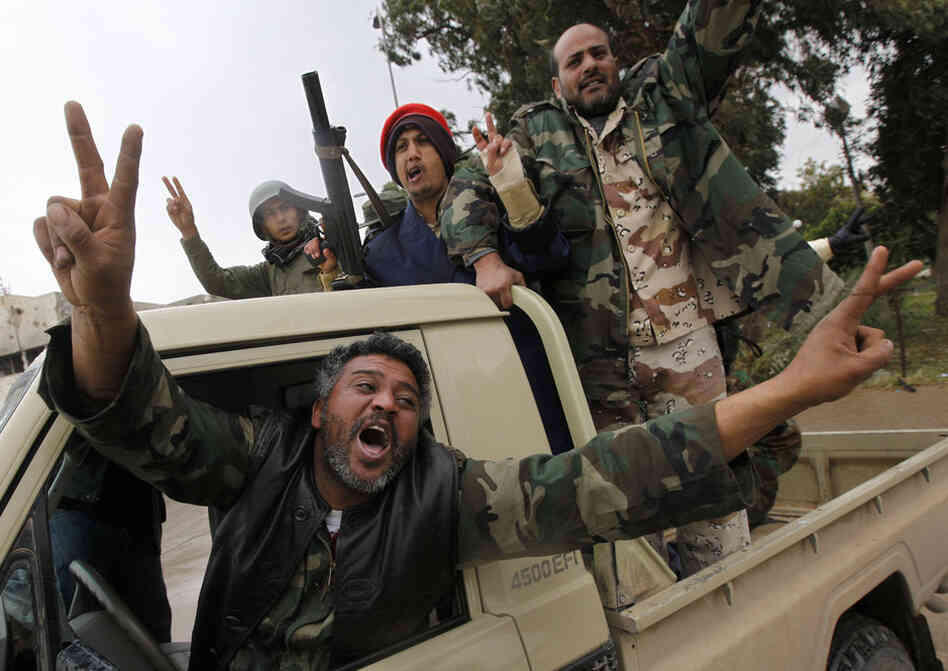 Rebels celebrate Sunday in the streets of Benghazi, no longer under the control of Gadhafi's government. 