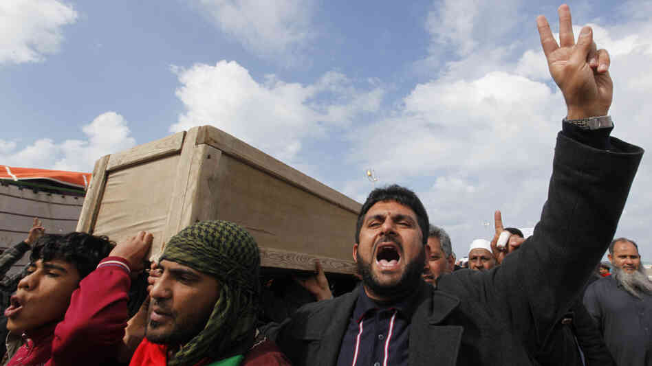 Libyian men carry the coffin of a protester who was killed during a recent demonstration. Libyian men carry the coffin of a protester who was killed during a recent demonstration.