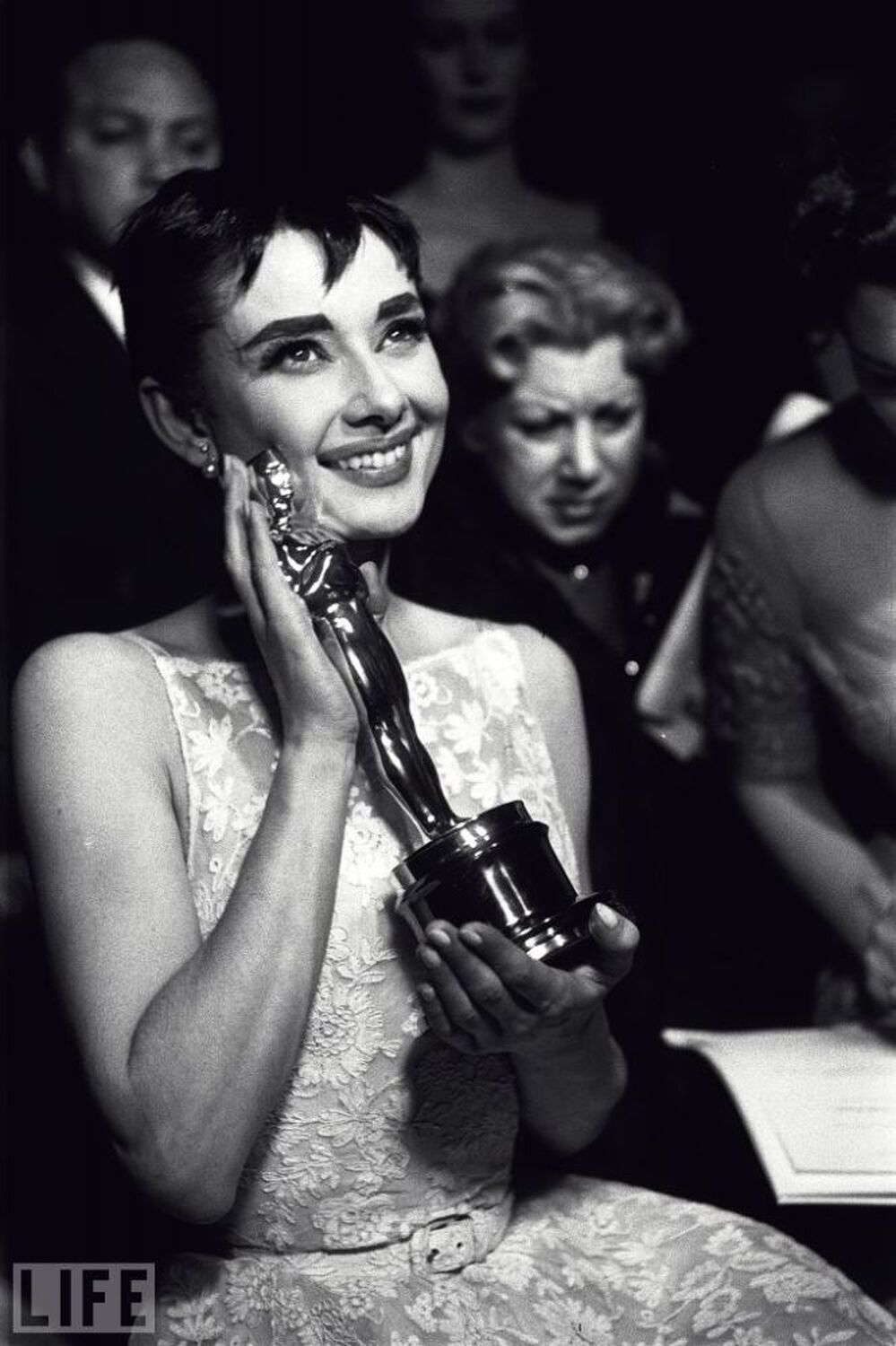 At the 1954 Academy Awards, Audrey Hepburn cradles the Oscar for best actress, awarded for her first lead role and her first Hollywood movie, Roman  Holiday.