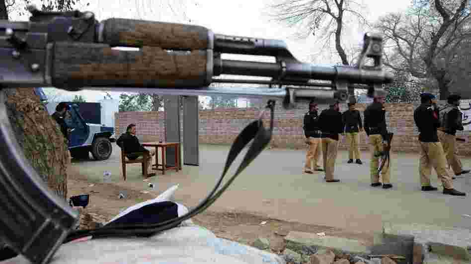 Pakistani police stand guard outside the Kot Lakhpat jail during today's court hearing.