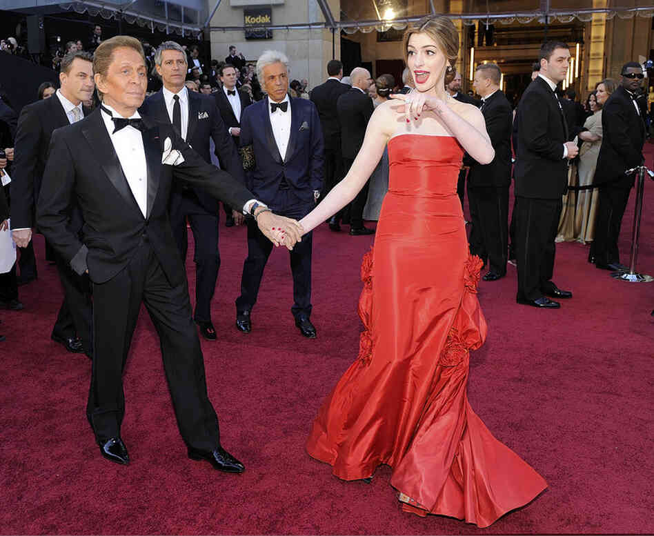 Oscar co-host Anne Hathaway poses with Valentino, who designed her dress. 