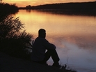Man sitting by river. iStockphoto.com. Man sitting by river. iStockphoto.com.