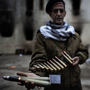 A Libyan rebel fighter displays heavy caliber ammunition found at a military barracks in Benghazi on Sunday.