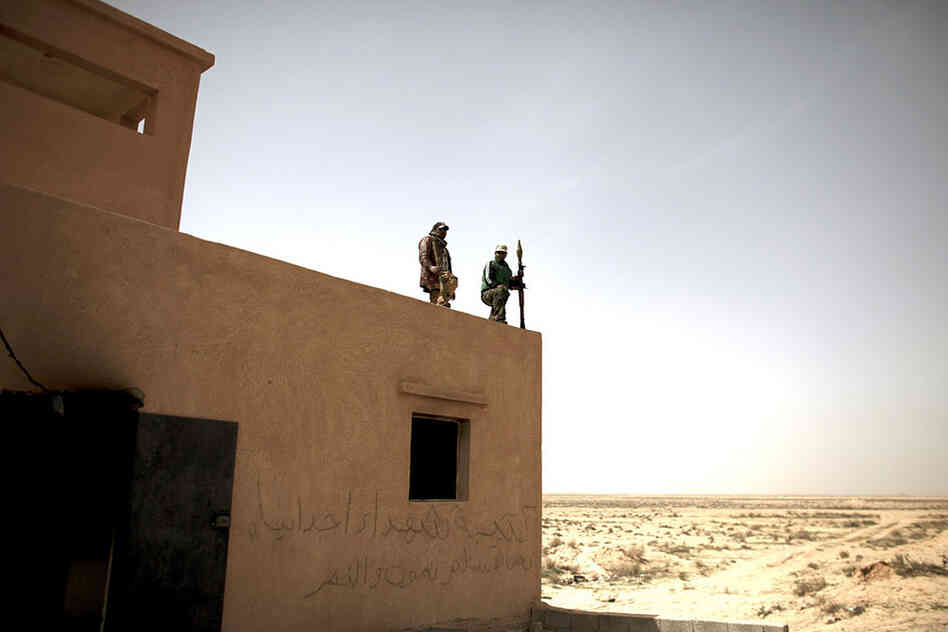 Defected Libyan soldiers stand guard outside an army base in the eastern town of Ajdabiya, Libya, on Tuesday. Eastern cities are free from government control, but fighting continues around the capital Tripoli, controlled by Libyan leader Moammar Gadhafi. 