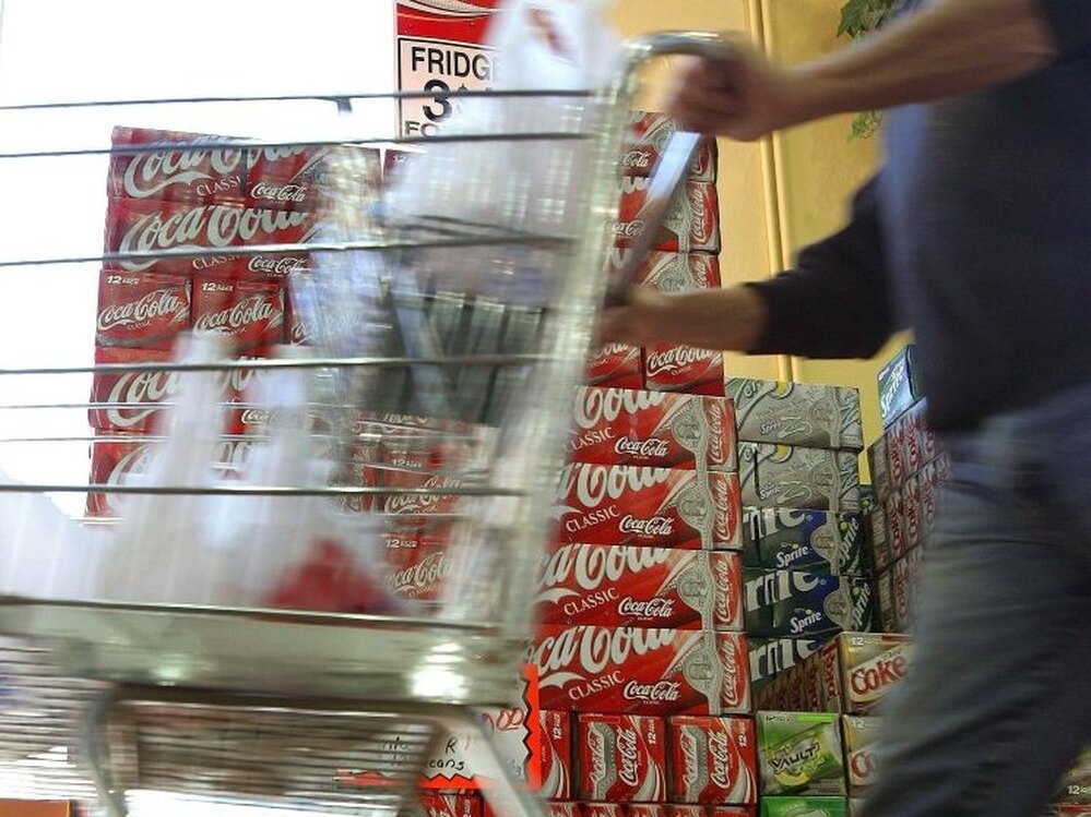 This shopper may be doing the right thing by driving his cart right by the soda display.