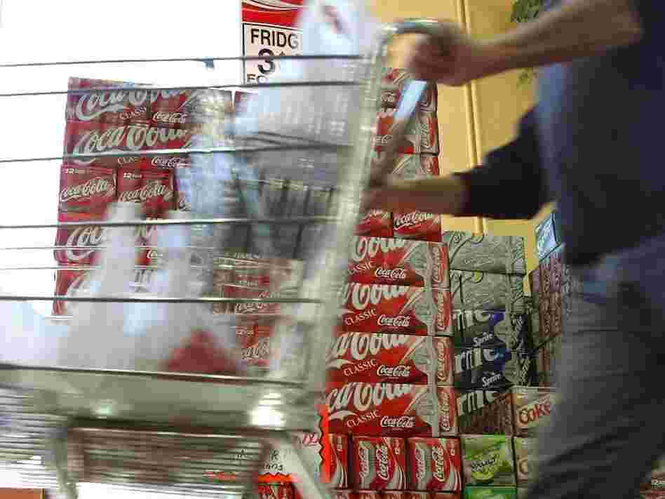 This shopper may be doing the right thing by driving his cart right by the soda display.