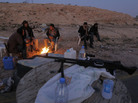 Libyan anti-government fighters sit by a fire to stay warm as they control a checkpoint on the outskirts of the southwestern town of Nalut, Libya, Monday. The town is currently in control of the Libyan anti-government forces. Libyan anti-government fighters sit by a fire to stay warm as they control a checkpoint on the outskirts of the southwestern town of Nalut, Libya, Monday. The town is currently in control of the Libyan anti-government forces.