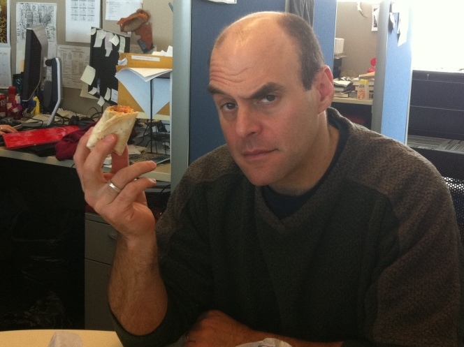 Peter holds the Beefy Crunch Burrito.